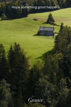 an image of a house in the middle of a field with trees and grass on both sides