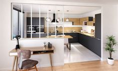 an open kitchen and dining area with wooden flooring, black cabinetry, and white walls