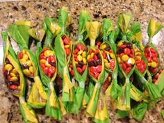 several candy candies wrapped in green paper on a counter top with yellow wrapping around them