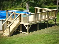 an above ground pool with steps leading up to the deck and above ground swimming pool