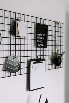 a black and white wall mounted to the side of a wall with calendars on it