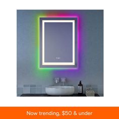 a bathroom with a sink, mirror and colorful lights on the wall above it that reads now trending $ 50 & under