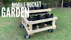 a mobile bucket garden cart with potted plants on it and the words mobile bucket garden