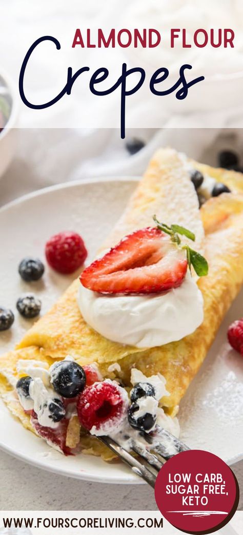 Almond flour crepe on a white plate filled with creamy filling, blueberries, raspberries, and strawberries with a silver fork taking a bite Breakfast Ideas With Almond Flour, No Carb Crepes, Crepes With Almond Flour, Keto Crapes Recipes Easy, Almond Flour Crepes Recipes, Keto Crepes Recipe Easy, Low Carb Crepes Recipe, Almond Flour Breakfast Recipes, Low Calorie Crepes