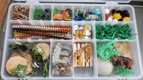 Includes: 10 count animals, fence, greenery, small and medium garden stones, wood slices, glass stones, crinkle paper, 8oz of play dough, animal print stems and poms, 3 cups of green rice, 1 cup of sand. Set this bin up in a zoo-like setting or a Safari! Let the kiddos imagination run wild 🐯 *This kit will be packaged in a clear bin. Wooden tray not included* Playdough is homemade with non-toxic ingredients. Safari Sensory Bin, Fence Greenery, Montessori Gifts, Tinker Box, Loose Parts Play, Play Dough Kit, Clear Bins, Green Rice, Playdough Kits