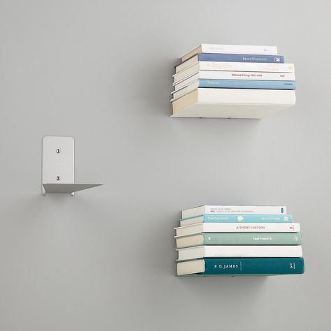 A set of floating shelves that turns books (the most beautiful things of all!) into storage units in and of themselves. Floating Book Bookshelf, Invisable Book Shelves, Coffee Table Book Holder, Reading Nook Floating Shelves, Invisible Floating Bookshelves, Book Shelves Floating, Book Shelves Aesthetic Bedroom, Organize Books Without Bookshelf, Book Organization Small Spaces