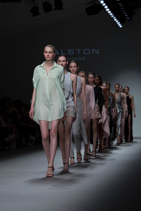 several models walk down the runway at london fashion week