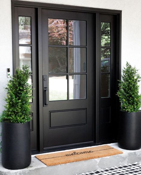 THE DESIGN DEN HOMES INC. | In Feng Shui, they say a black front door absorbs, attracts, and brings in positive energy to a home, making it a favourable colour choice… | Instagram Black Steel Doors Exterior, Front Doors On Black Houses, Black Glass Front Door Modern, Black Front Door Colonial House, Black Glass Front Doors, Front Door Glass Side Panels, Front Door House Design, Modern Black Exterior Door, Big Front Door Entrance