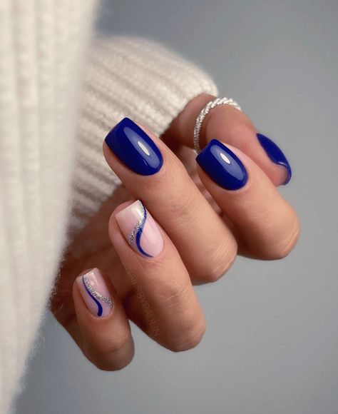 Find inspiration for 55 beautiful blue winter nail designs from solid to ombre to glitter styles perfect for the cold season. Get ideas for French tips with blue, royal, and navy polish, snowflake nail art, and swirling or marbled looks that capture the icy essence of winter. #winter #winterstyle #wintermanicure #bluenails #winternails #lightbluenails $royalbluenails #darkbluenails #navybluenails Navy And Silver Nails, Blue Winter Nails, Navy Blue Nail Designs, Nail Art Bleu, Royal Blue Nails Designs, Blue Prom Nails, Blue And Silver Nails, Blue Gel Nails, Royal Blue Nails