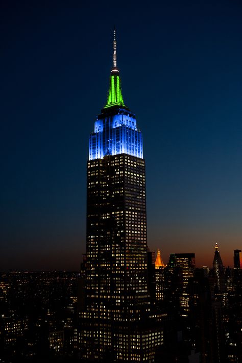 June 16, 2015: The Empire State Building shines in blue, green and white to honor mentorship organization Big Brothers Big Sisters of NYC and its 16th annual Casino Jazz Night benefit. Madison Square Garden, Tower Light, The Empire State Building, Ellis Island, Yankee Stadium, I Love Ny, 5th Anniversary, March 6, City That Never Sleeps