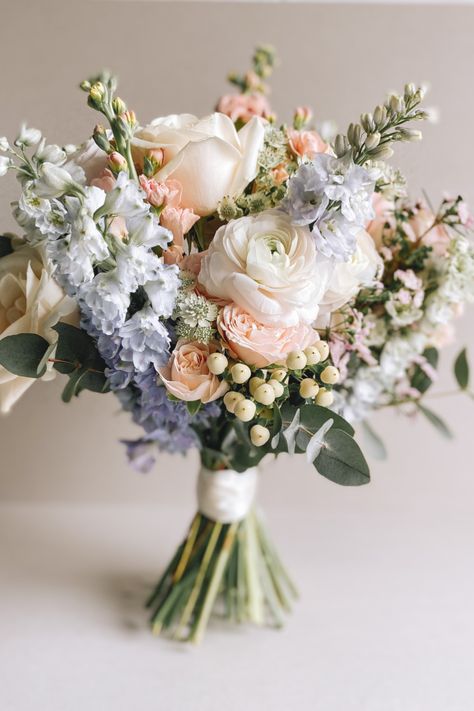 Pastel Blue and Pink Bouquet full of scent and texture. Flowers include Stocks, Delphiniums, Roses, Waxflower, & Hypericum Pastel Flower Arrangements Wedding Ideas, White And Pastel Bouquet, Blue Pink Wedding Bouquet, Peach Flowers Bouquet, Dusty Blue And Pink Bouquet, Pink White And Blue Bouquet, Pastel Blue Bouquet, White Pink And Blue Bouquet, Pink White Blue Bouquet