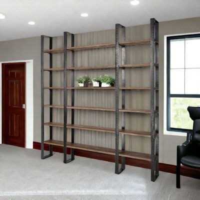 Sturdy and built to last, this 90-inch brown and black wood and iron six-tier bookcase helps you display your books, files, photos, plants, and treasures in an organized fashion. This large shelving unit features 6 shelf tiers made of solid wood in a light brown weathered/natural finish that is flanked by black hammered iron supports for a modern industrial look and feel. Increase your room's capacity for storage and display with this great open-back large shelving unit. 89.76-inch H x 84.06-inc Industrial Design Style, Metal Beam, Industrial Bookshelf, Hammered Iron, Pharmacy Design, Iron Shelf, White Bookcase, Frame Shelf, Wood Joinery