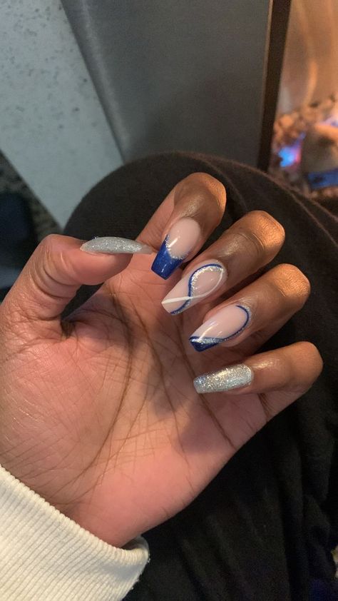 May Nail Art Trends: Summer-ready Styles to Try Indigo Prom Nails, White Silver Blue Nails, Nail Ideas Blue And Silver, Dark Royal Blue Nails Acrylic, Blue Nails Silver Accent, Dark Blue Nails With Silver Design, Navy Blue And Cream Nails, Winter Nails Blue Silver, Blue And Silver Acrylic Nails Prom