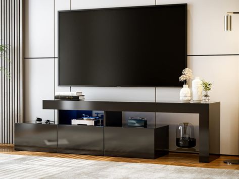 PRICES MAY VARY. 🟨 【Modern TV Stand for 75+ inch tv】-- This LED entertainment center is perfect to support 75" TVs in plasma, LED, OLED, and LCD options, which means the TV & media furniture game console cabinet is designed for your home decor/office/bedroom/living room. 🟥 【Changing Colors LED Lights】-- Life needs a sense of ritual, colorful lights make your life relax and exciting. The LED TV Stand includes 16 Colors, 4 Lighting Patterns. You can change lights by wireless remote at ease. 🟩 【 Black Tv Cabinet, 75 Inch Tv, Tv Media Console, Game Room Bedroom, Wood Tv Console, Led Tv Stand, Media Console Table, White Tv Stands, Tv Console Table