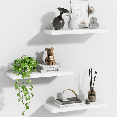 Set of 3 Modern Style Floating Shelves Wall Mounted for Decor, White These floating Shelves add a classic touch to bedrooms, living rooms, kitchens, and home offices. The invisible shelves floating shelves can help make full use of your empty walls, which is much more space-saving. They can not only organize daily sundries to make your space tidy and neat, they can also display your art pieces on the wall to decorate your home and make it full of aesthetic flare. Size: 15inchL x 6.7inchW x 1.4in White Hanging Shelves Bedroom, White Shelves For Bedroom, How To Place Shelves On A Wall, Modern Floating Shelf Decor, Floating Shelves For Bedroom, White Bedroom Shelves, Bathroom Floating Shelf Decor, Modern Shelf Decor Living Room, Floating Office Shelves