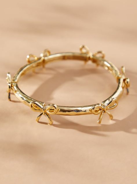 This delicate gold bow bracelet adds a touch of girly to your wrist. The gold bows stand out and the stretchy band ensures a comfortable fit for all-day wear. Dress it up or down, this bracelet is a versatile addition to any jewelry collection. Nice Gold Jewelry, Tiffany And Co Gold Jewelry, Elegant Jewelry Classy Gold, Wrist Jewelry Aesthetic, Cute Jewelry Gold, Pretty Gold Jewelry, Ring Inspo Gold, Gold Jewelry Inspiration, Cute Gold Bracelets