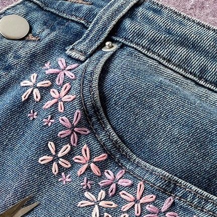 Lia Griffith on Instagram: "These Flower Embroidered Jeans are a great way to give you or your kiddos’ favorite beat-up old jeans a spring glow-up! Using our trusty lazy daisy stitch, we’ll have you feeling “flower-powerful” in no time. https://liagriffith.com/flower-embroidered-jeans/ This beginner-friendly project is perfect for those cozy January afternoons when you’re yearning for a creative escape. #DIYJeans #UpcycledFashion #EmbroideryCraft #HandmadeJeans #SustainableStyle #FlowerEmbroidery #CraftyFashion #CustomDenim #FashionUpcycle #DenimCraft #DIYStyle #EcoFashion #JeansRevamp #CreativeStitching #UpcycledClothing #EmbroideryArt #DIYFashionista #SewMuchStyle #FashionCrafting #GreenFashion #MadeWithLia" Embroidery Flowers Beginner, Flower Patches On Jeans, Jean Pocket Embroidery Flowers, Embroidery On White Jeans, Embroidered Jeans Pocket Flowers, Diy Embroidered Flowers, Embroidering On Jeans, Embroidered Hem Jeans, Jeans Embroidery Tutorial