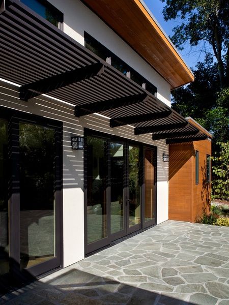 metal entry door awnings | Dark Metal Awning Over Patio Doors Door Canopy Modern, Chalet Modern, Metal Entry Doors, Pergola Modern, Front Door Awning, Ruang Tamu Outdoor, Front Door Canopy, Metal Awning, Garage Pergola