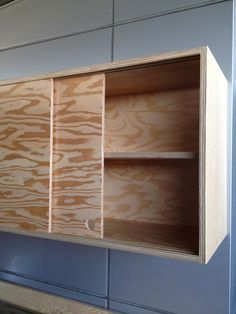 Sliding cabinet doors and discreet handles keep the piece looking sleek. Kitchen Cabinets Sliding Doors, Sliding Cabinet Doors, Diy Cabinet Doors, Plywood Kitchen, Cabinets Bathroom, Kabinet Dapur, Plywood Cabinets, Kitchen Wood, Diy Drawers