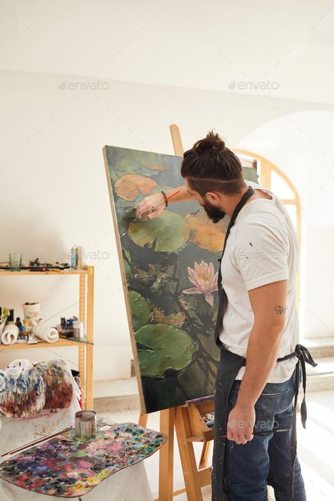 Modern Bearded Man Painting on Easel in Studio by seventyfourimages. Vertical back view portrait of talented male artist painting picture on easel while working in spacious art studio li... #Sponsored #seventyfourimages, #Studio, #Vertical, #portrait Men Art Photography, Man Artist Aesthetic, Man Drawing Aesthetic, Men Painting Aesthetic, Male Painter Photography, Male Artist Photoshoot, Man Painting Aesthetic, Male Painter Aesthetic, Art Easel Aesthetic