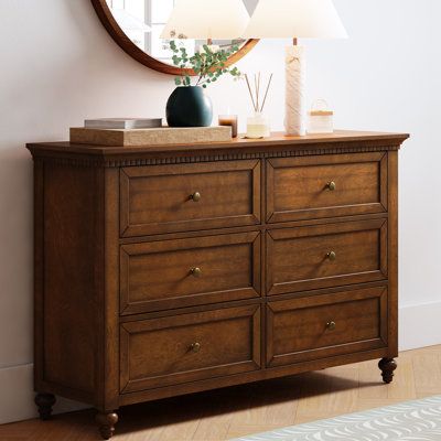 Elegant pieces don't have to be flamboyant or over the top. This contemporary dresser proves that even the simplest designs can be sophisticated and charming. It's right for almost any occasion and makes any space look amazing especially the bedroom. This is a wood 6-drawer dresser with storage for clothing, bedding, accessories, and more. Large ring decorative hardware pulls on the four standard drawers and small knobs for the three centre drawers all in a champagne brass finish. The sleek dark Brown Dresser With Gold Handles, Bed And Dresser Set, Boy Bedroom Sets Furniture, Mission Bedroom Decor, Dresser For Small Room, Dark Brown Dresser Decor, Rustic Wood Dresser, Accent Dresser In Bedroom, Bedroom With Walnut Furniture