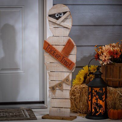 This rustic pine wood mummy is an inviting Halloween statue that will look great wherever it is placed. He proclaims 'Trick or Treat' and has a 'Boo' banner. | The Twillery Co.® Painted Wood Halloween Mummy Figurine Wood in Brown | 32 H x 9 W x 4 D in | Wayfair Natal, Figurine, Wood Halloween, Fall Wood Crafts, Hallowen Ideas, Halloween Wood Crafts, Pumpkin House, Halloween Crafts Decorations, Halloween Mummy