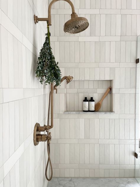 White vertical shower tiles with brass shower head and marblw accents by Laura Design and Co, Dallas interior designer Farmhouse Luxury Bathroom, Shoji White, Amazing Showers, Coastal Bathroom, Master Bath Remodel, Hus Inspiration, Bathroom Redo, House Bathroom, Bath Remodel