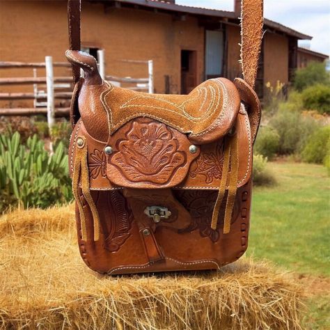 Discover The Charm Of Vintage Elegance With This Unbranded Crossbody Bag. Crafted From Genuine Leather In A Rich Caramel Brown, This Small Saddle-Shaped Bag Features Exquisite Floral Tooling That Adds A Touch Of Western Flair. The Adjustable Leather Strap Ensures A Comfortable Fit, While The Turnlock Closure Keeps Your Essentials Secure. This Bag Is Perfect For Casual Outings Or Adding A Unique Touch To Your Everyday Look. New Condition. Keywords: Crossbody Bag, Genuine Leather, Vintage, Floral Saddle Purse Handbags, Saddle Purse, Louis Vuitton Artsy Mm, Brown Crossbody Bag, Brown Crossbody, Brown Leather Shoulder Bag, Vintage Elegance, Caramel Brown, Black Leather Purse