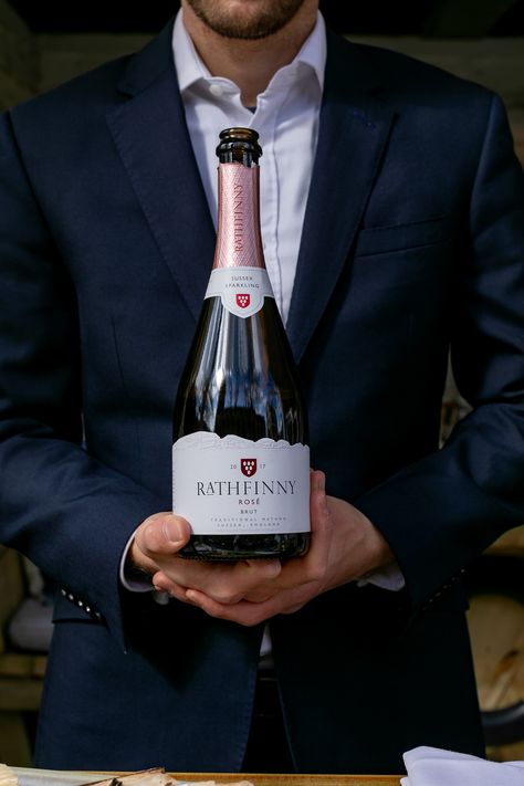 Sommelier holding a bottle of Sussex Sparkling wine. Wine Sommelier, Wine Merchant, Bottle Shop, Hotel Bar, Bar Restaurant, Sparkling Wine, Wine Bottle, Restaurant, Wine