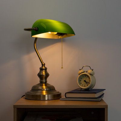 This lamp is similar to the classic look of a traditional mid-century green bank lamp. A green shade with a bronze base combines great lighting with beautiful style. The elegant design is carefully disguised by carefully selected durable materials that make this lamp long-lasting. | House of Hampton® Dontrice Classic Green Banker Desk Lamp w / Pull Chain Switch Glass / Metal in Green / Yellow | 21.65 H x 7.87 W x 7.87 D in | Wayfair Vintage Office Desk Lamp, Banker Desk Lamp, Green Glass Bedside Lamp, Green And Gold Lamp, Vintage Desk Lamps Office, Mid Century Fixtures, Home Lamps Decor, Bank Teller Lamp, Vintage Lamps Bedroom