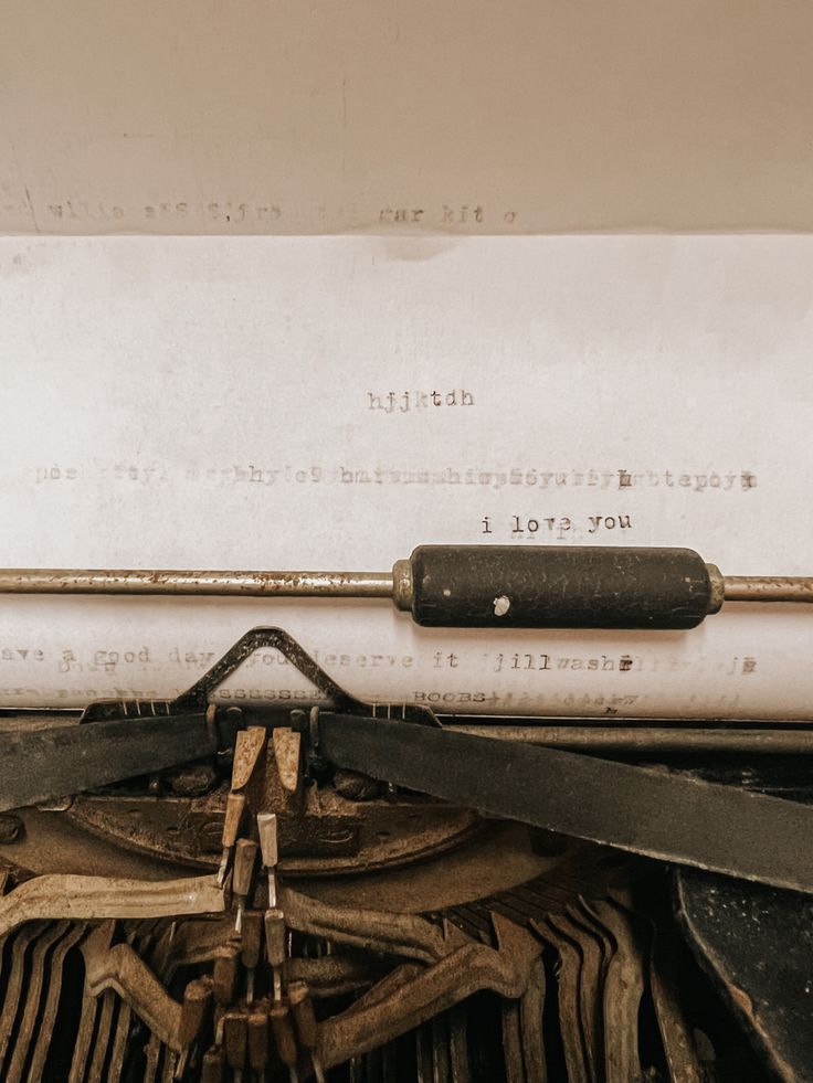 an old typewriter with the words i love you written on it's paper