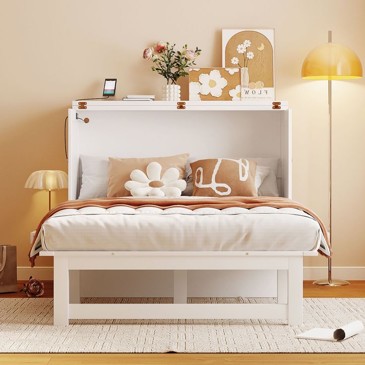 a white bed sitting in a bedroom on top of a hard wood floor next to a lamp