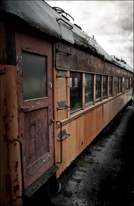 an old train car sitting on the tracks