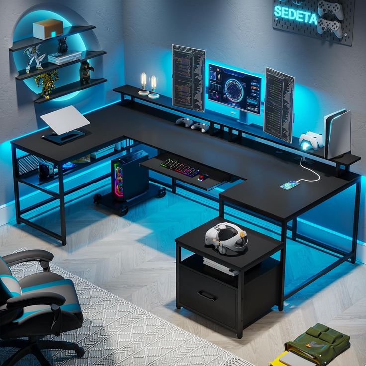 a computer desk with two monitors and a soccer ball on it in front of a blue light