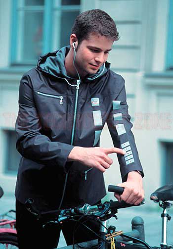 a man standing next to a parked bike in front of a building with his hand on the handlebars