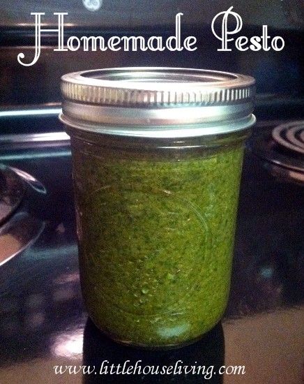 a jar filled with green pest sitting on top of a stove