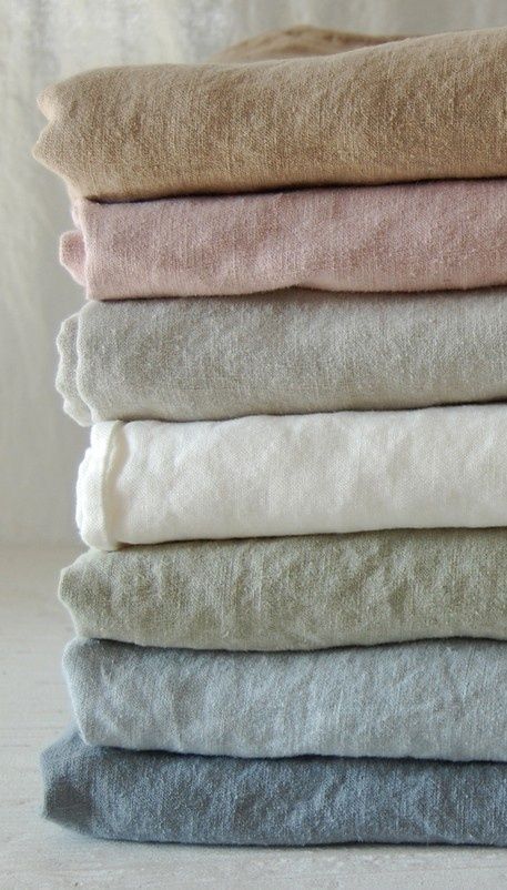 a stack of folded towels sitting on top of each other