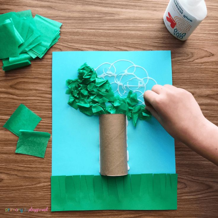 someone is making a paper tree out of toilet paper and tissue rolls on the table