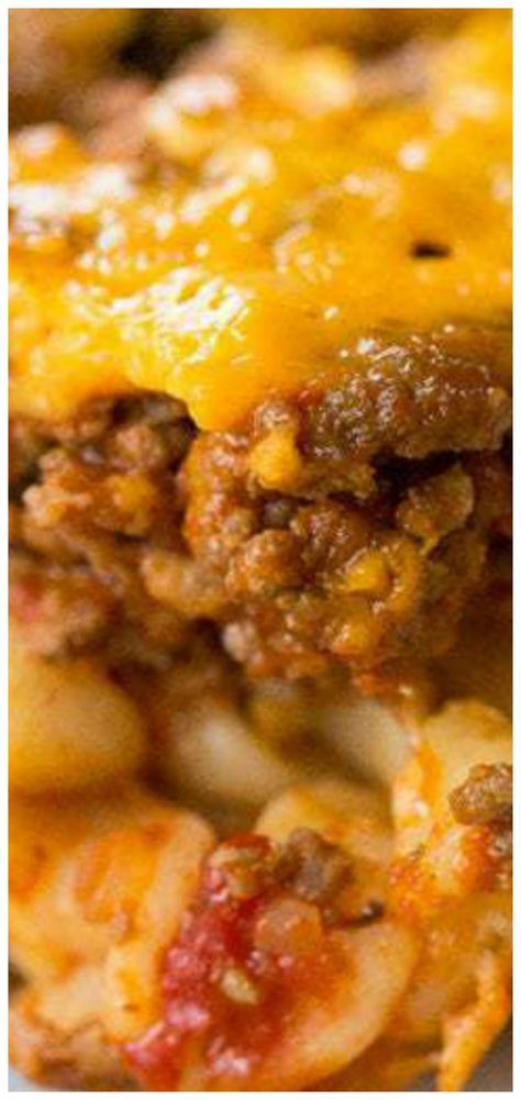 a close up view of some food with cheese and meat on it's surface