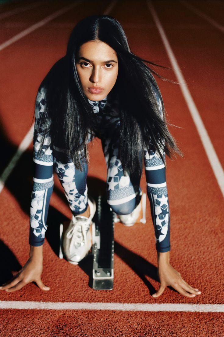 a woman is doing push ups on a track