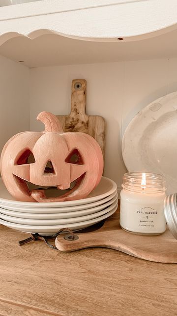 a wooden carved pumpkin sitting on top of plates