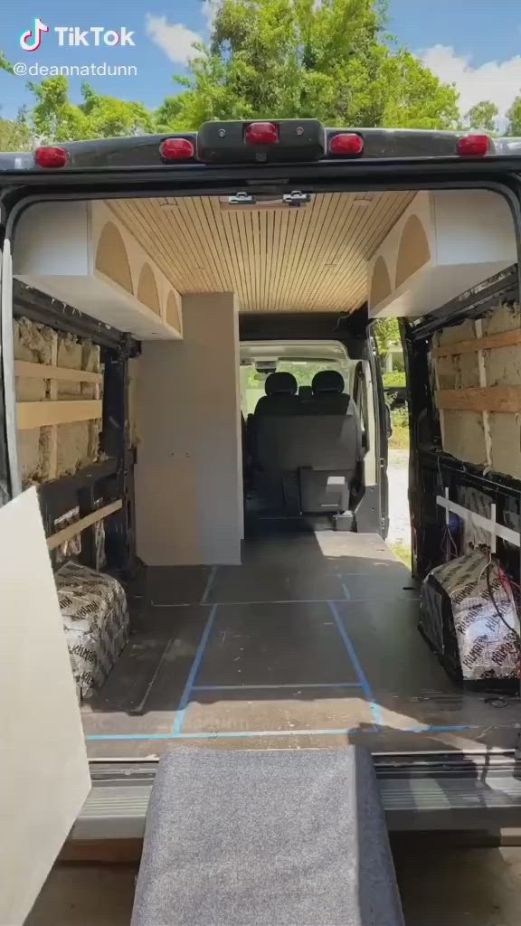 This may contain: the inside of a van with its doors open