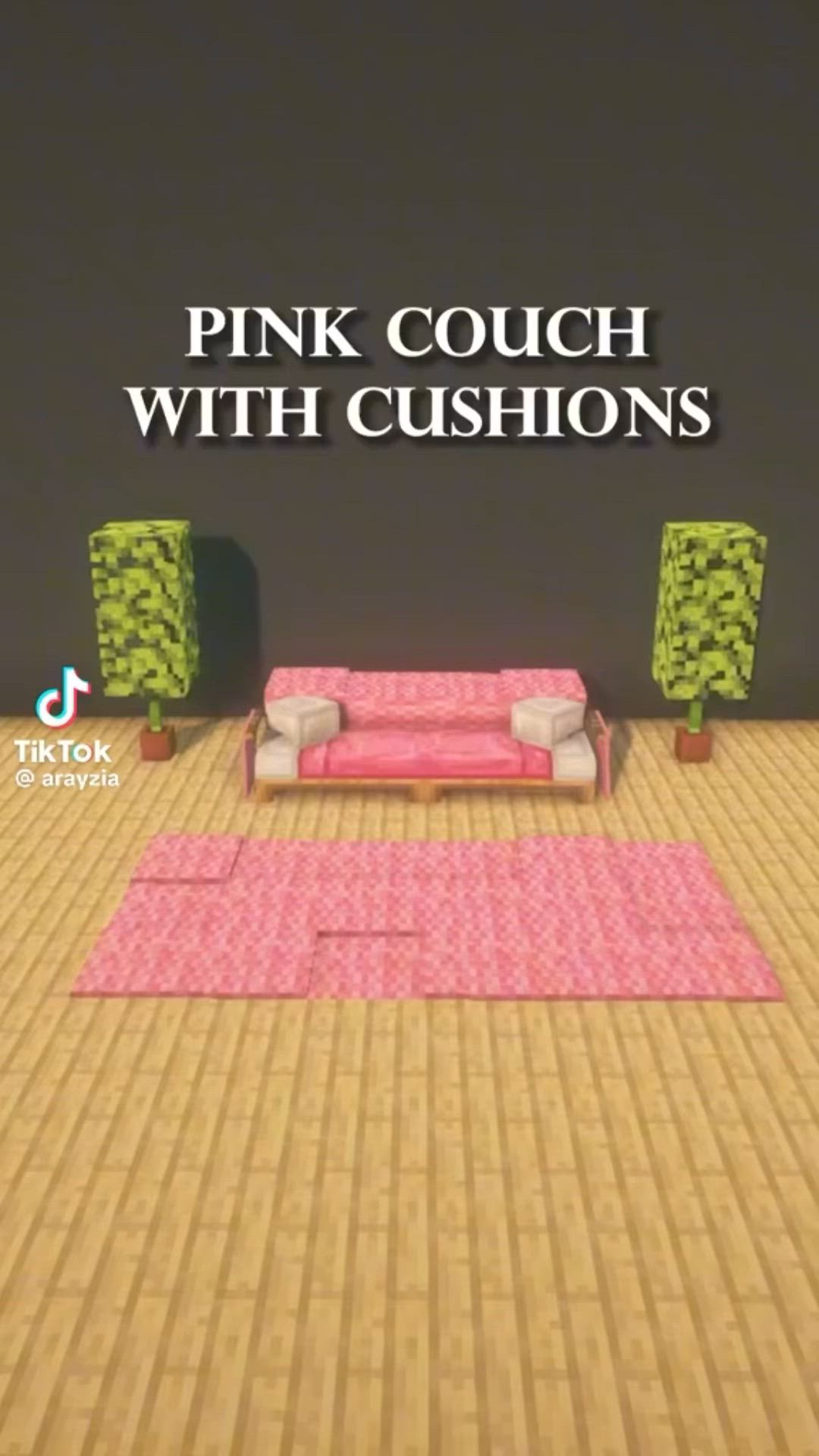 This may contain: pink couch with cushions on the floor in front of a black wall and green chairs