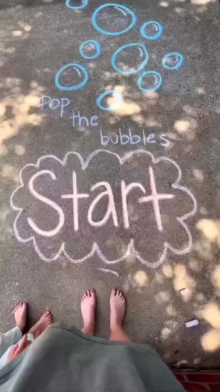 This may contain: two people standing in front of a chalk drawing on the ground with words start and pep the bubbles