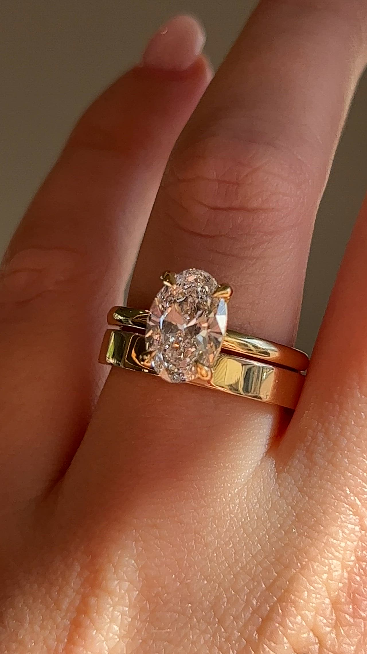 This may contain: a woman's hand with a ring on it and a diamond in the middle