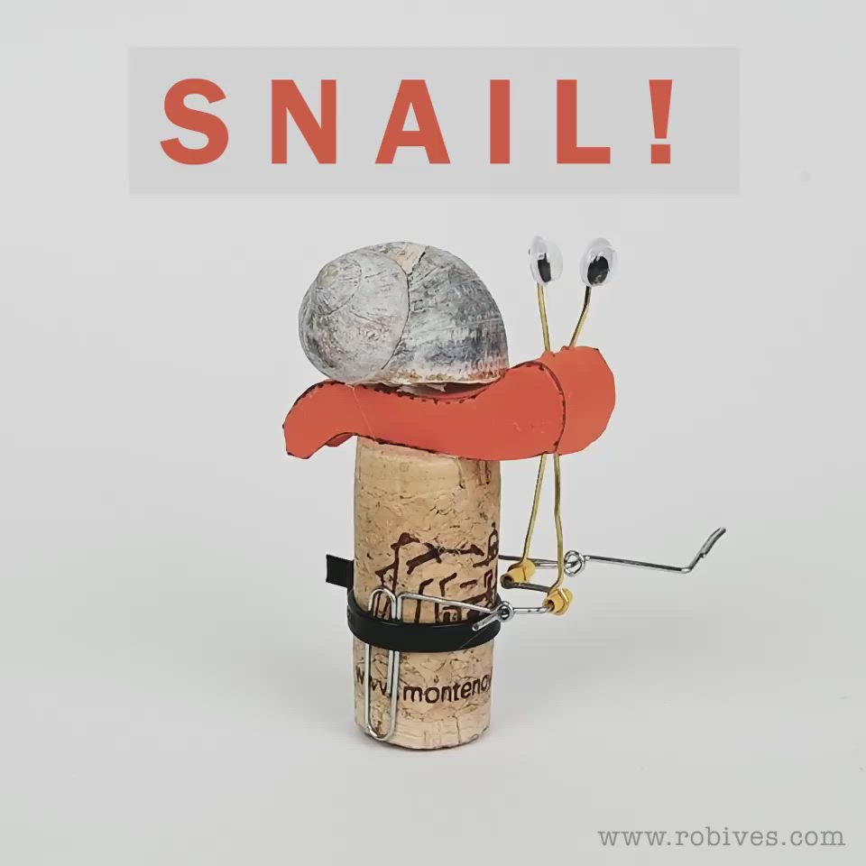 This may contain: there is a small toy made out of wine corks with the words snail on it