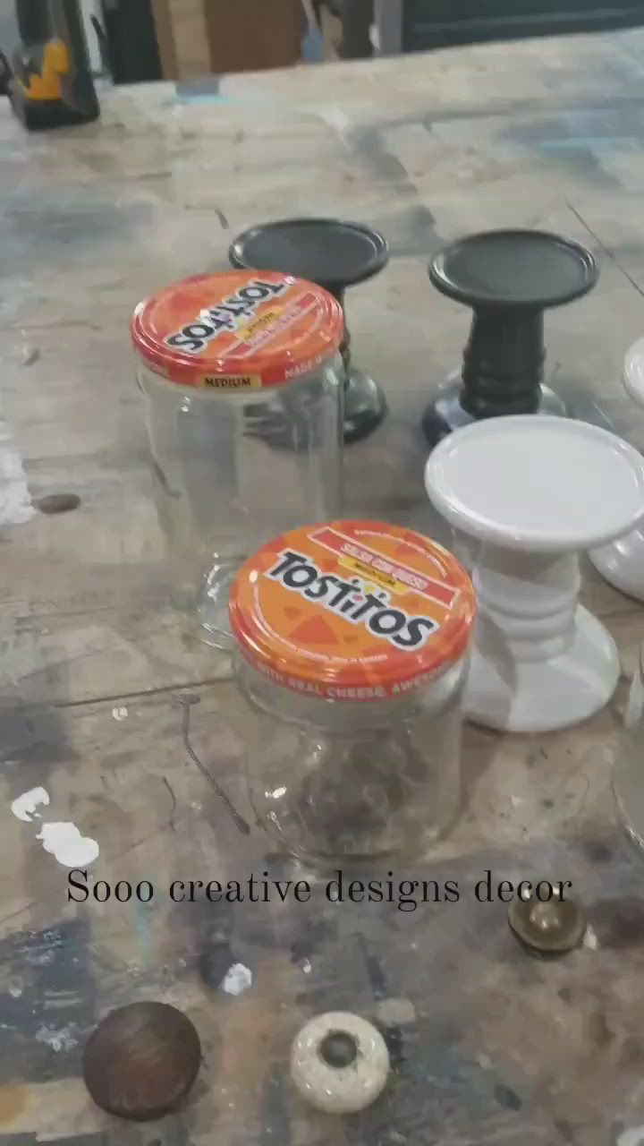 This may contain: three plastic containers sitting on top of a table covered in buttons and doughnuts