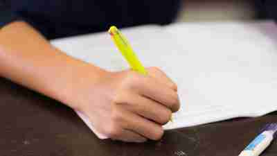 A student filling out a weekly homework chart as outlined in his 504 plan.