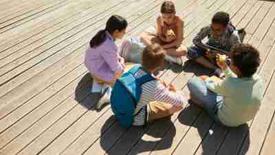 A group of children sitting in a circle, becoming friends