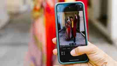 Person taking a photo of a student graduating from college. What to do when facing social media envy re: college graduaion.